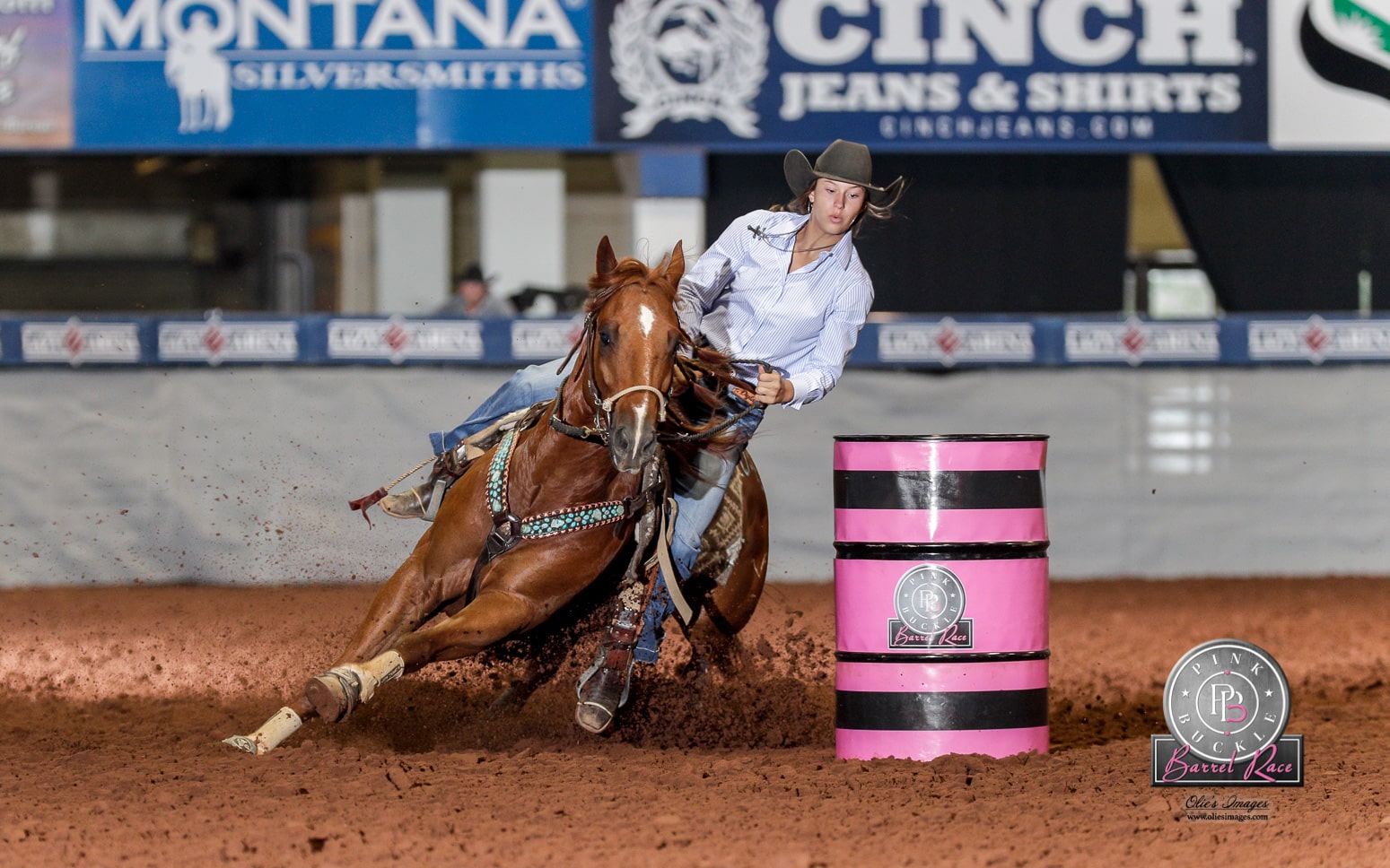 woman riding horse around pink barrel