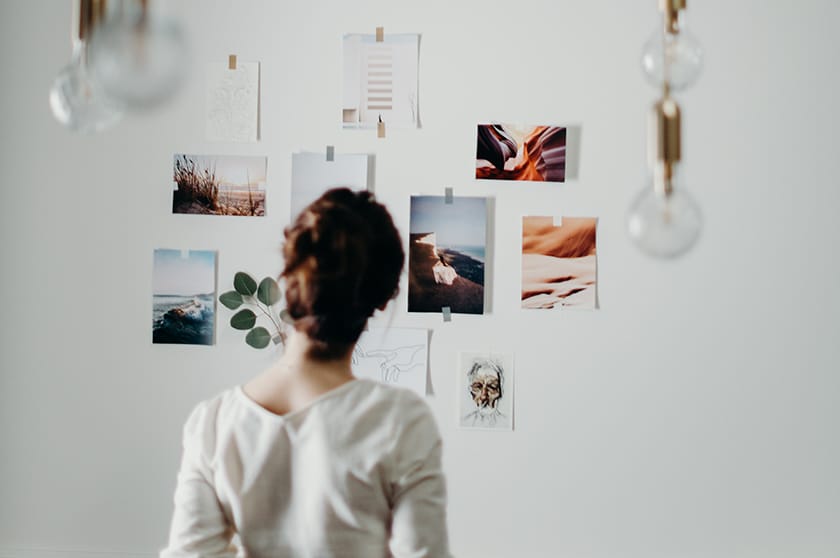person looking at photos on wall online photography portfolio