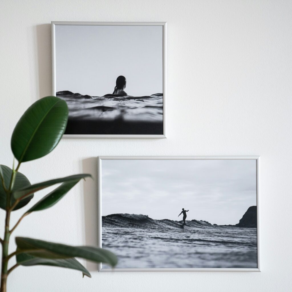 wo framed b&w photographs of a person in the ocean